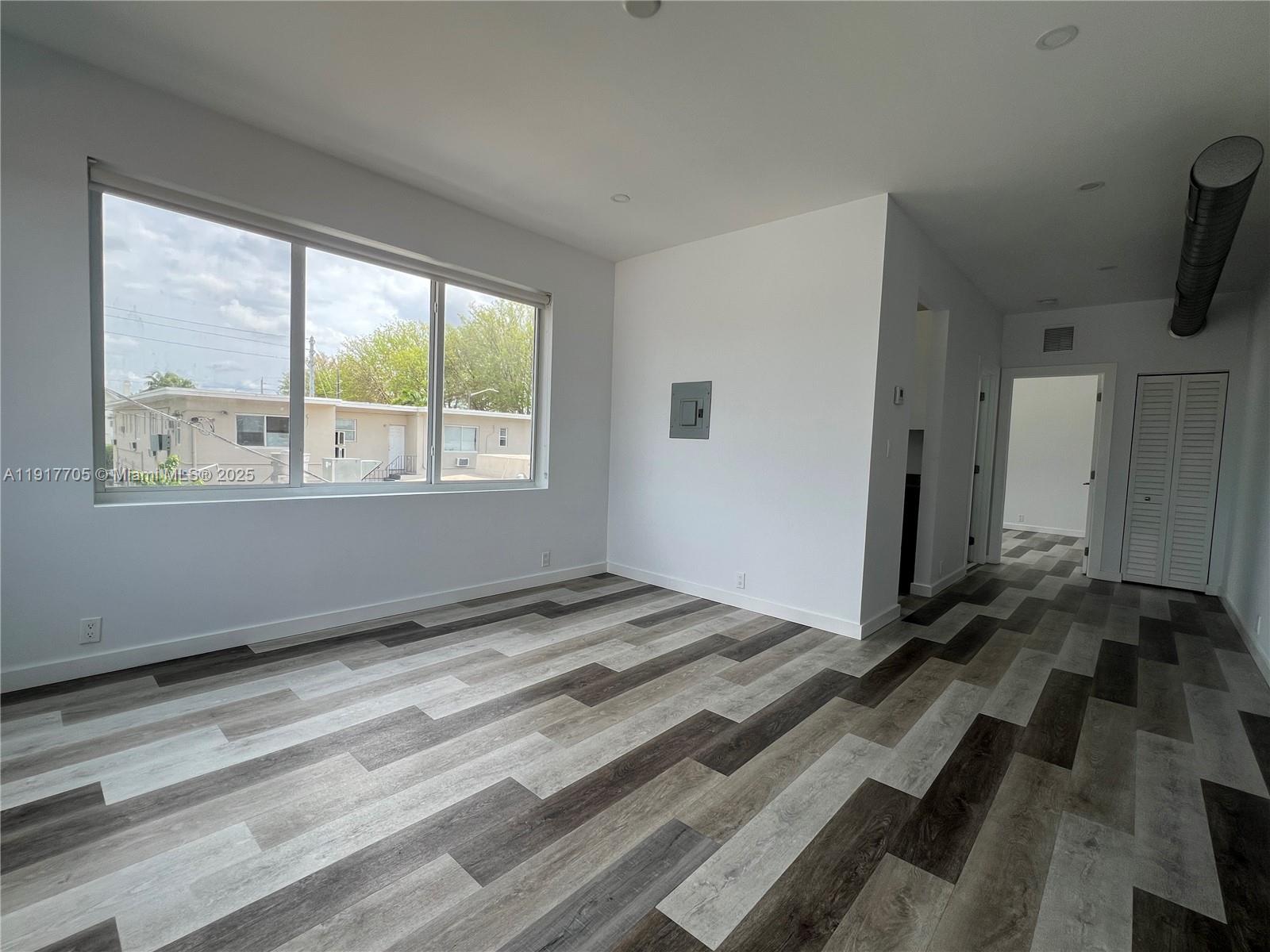 1814 Southwest 22nd Avenue, Unit 4 Miami, FL 33145 - Photo 2 of 11 a view of a bedroom with wooden floor and a window