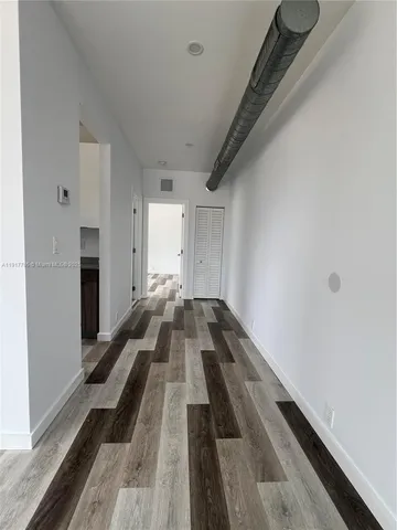 a view of a bedroom with wooden floor and staircase