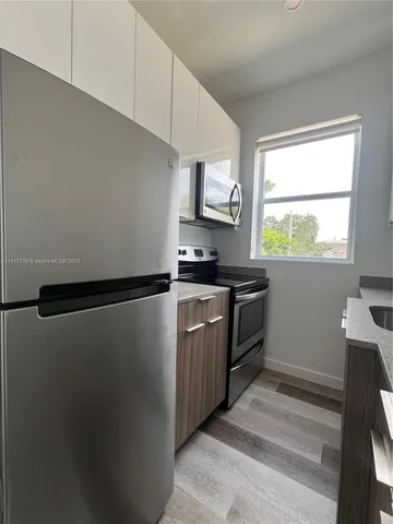 a kitchen with a refrigerator sink and stove