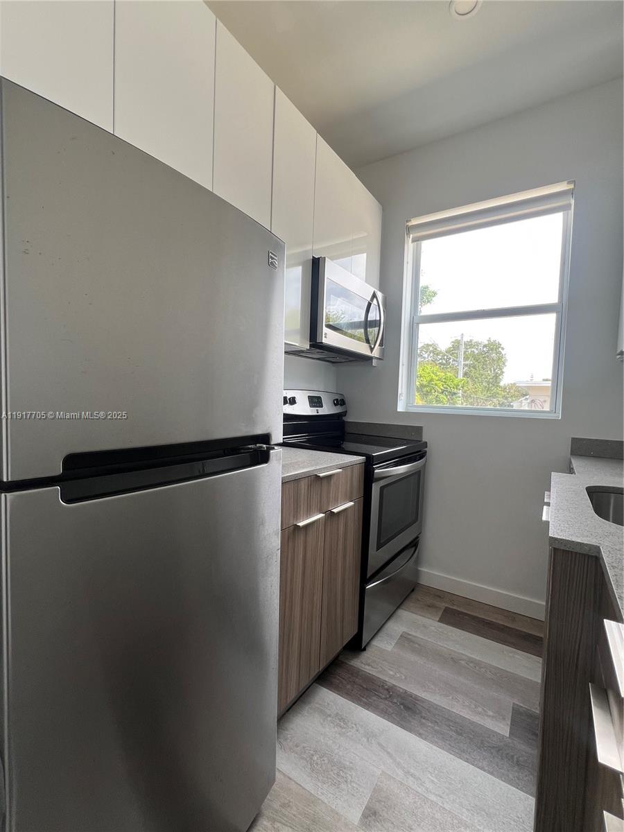 1814 Southwest 22nd Avenue, Unit 4 Miami, FL 33145 - Photo 4 of 11 a kitchen with a refrigerator sink and stove