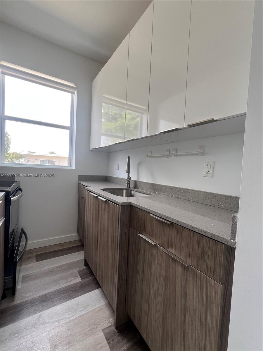 1814 Southwest 22nd Avenue, Unit 4 Miami, FL 33145 - Photo 5 of 11 a kitchen with a sink and cabinets