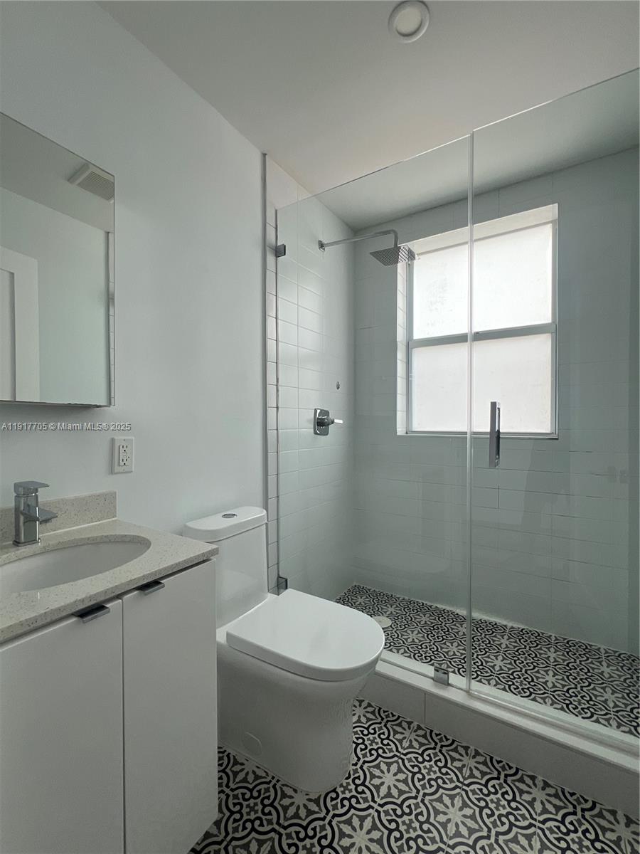 1814 Southwest 22nd Avenue, Unit 4 Miami, FL 33145 - Photo 6 of 11 a bathroom with a sink a toilet and shower