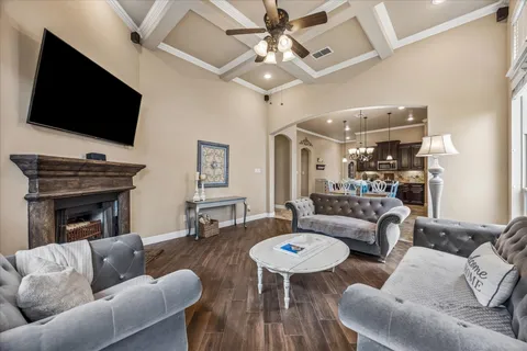 a living room with a bed furniture and a chandelier