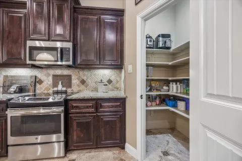 a view of walk in closet with clothes