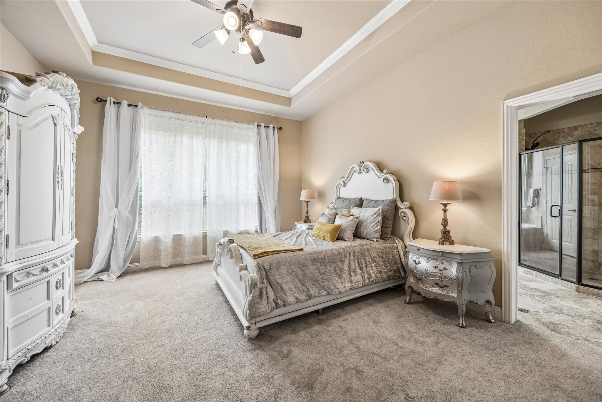 108 Rhinestone Cove Liberty Hill, TX 78642 - Photo 16 of 32 Carpeted room with a tray ceiling and ceiling fan