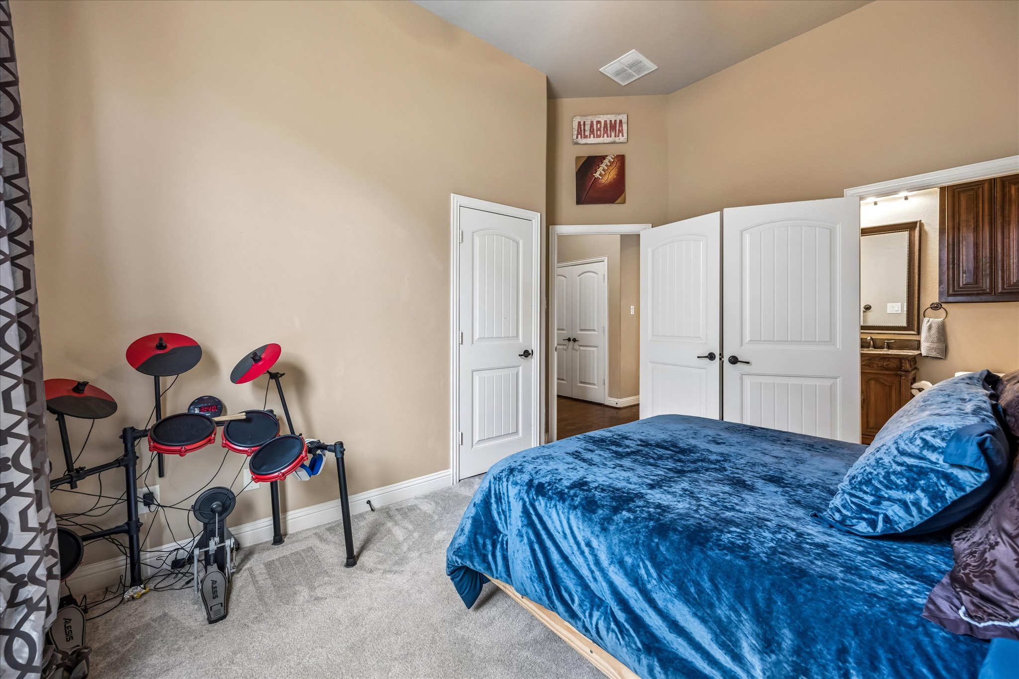 108 Rhinestone Cove Liberty Hill, TX 78642 - Photo 22 of 32 Carpeted room with vaulted ceilings and neutral wall tones