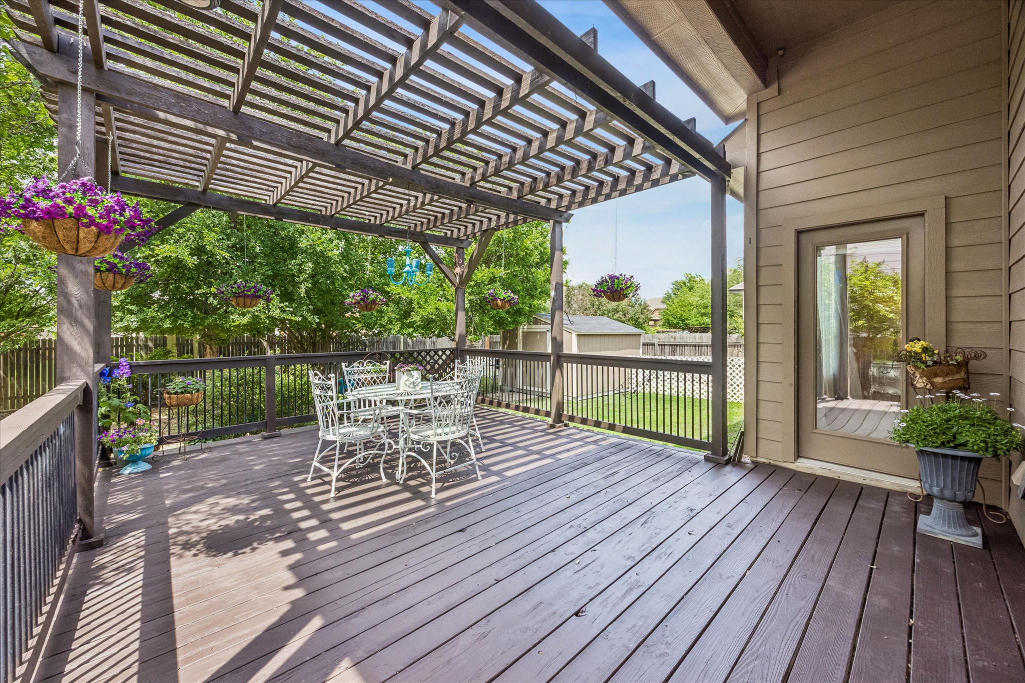 108 Rhinestone Cove Liberty Hill, TX 78642 - Photo 27 of 32 Expansive outdoor deck featuring wood-finish flooring, a full pergola, and a private backyard with a manicured lawn