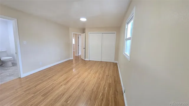 a view of wooden floor and windows in a room