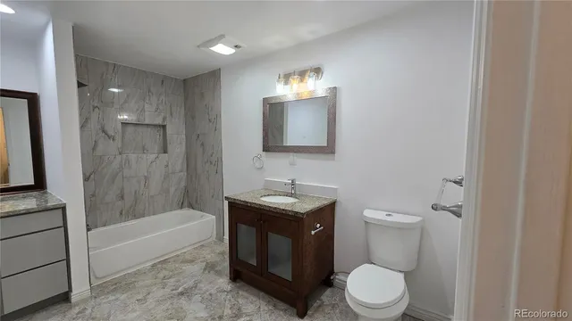 a bathroom with a toilet a sink and bathtub