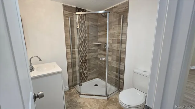 a bathroom with a toilet sink and shower