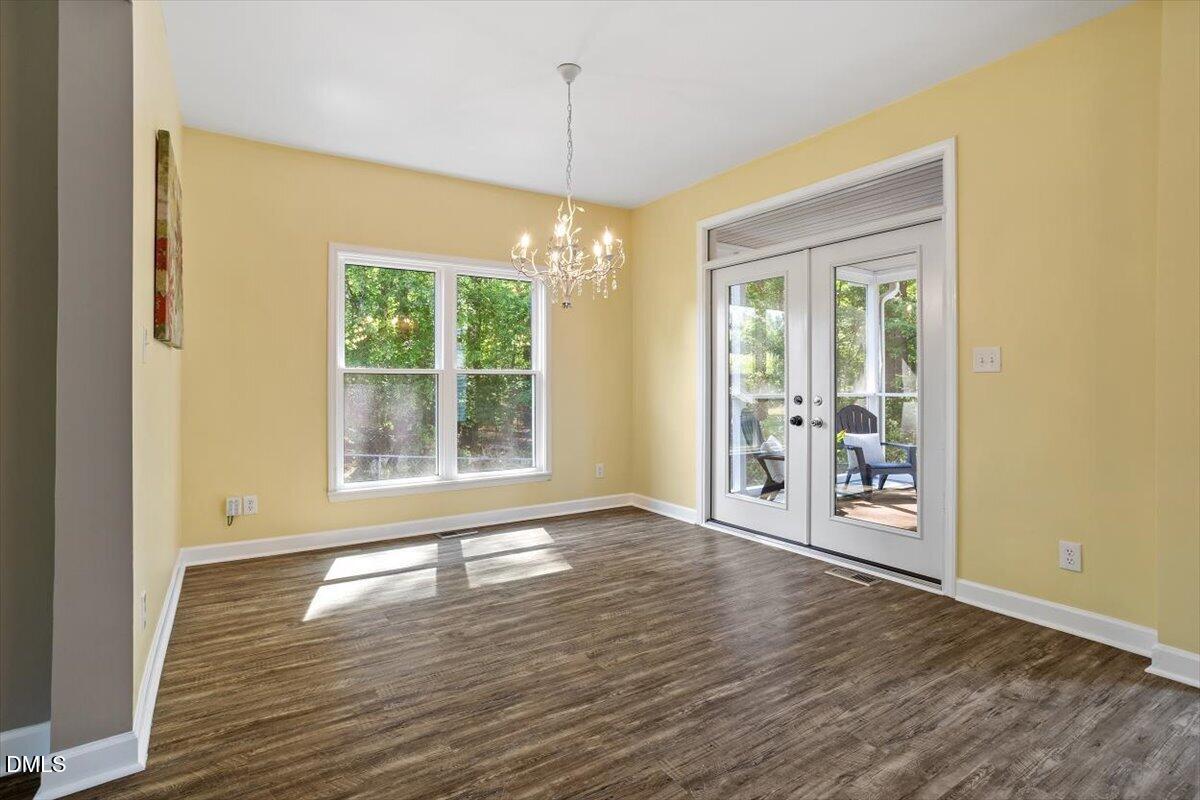 7505 Penny Road Raleigh, NC 27606 - Photo 15 of 35 a view of an empty room with wooden floor and a window