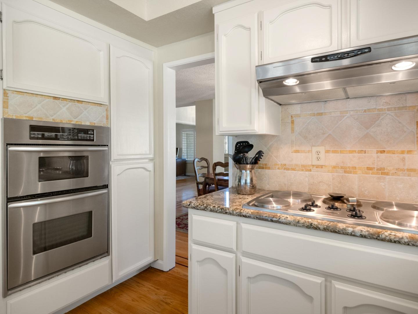 7026 Burnside Drive San Jose, CA 95120 - Photo 12 of 60 a kitchen with granite countertop stainless steel appliances and wooden cabinets
