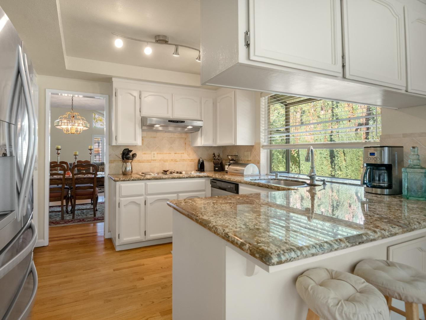 7026 Burnside Drive San Jose, CA 95120 - Photo 14 of 60 a kitchen with stainless steel appliances granite countertop a sink stove and cabinets