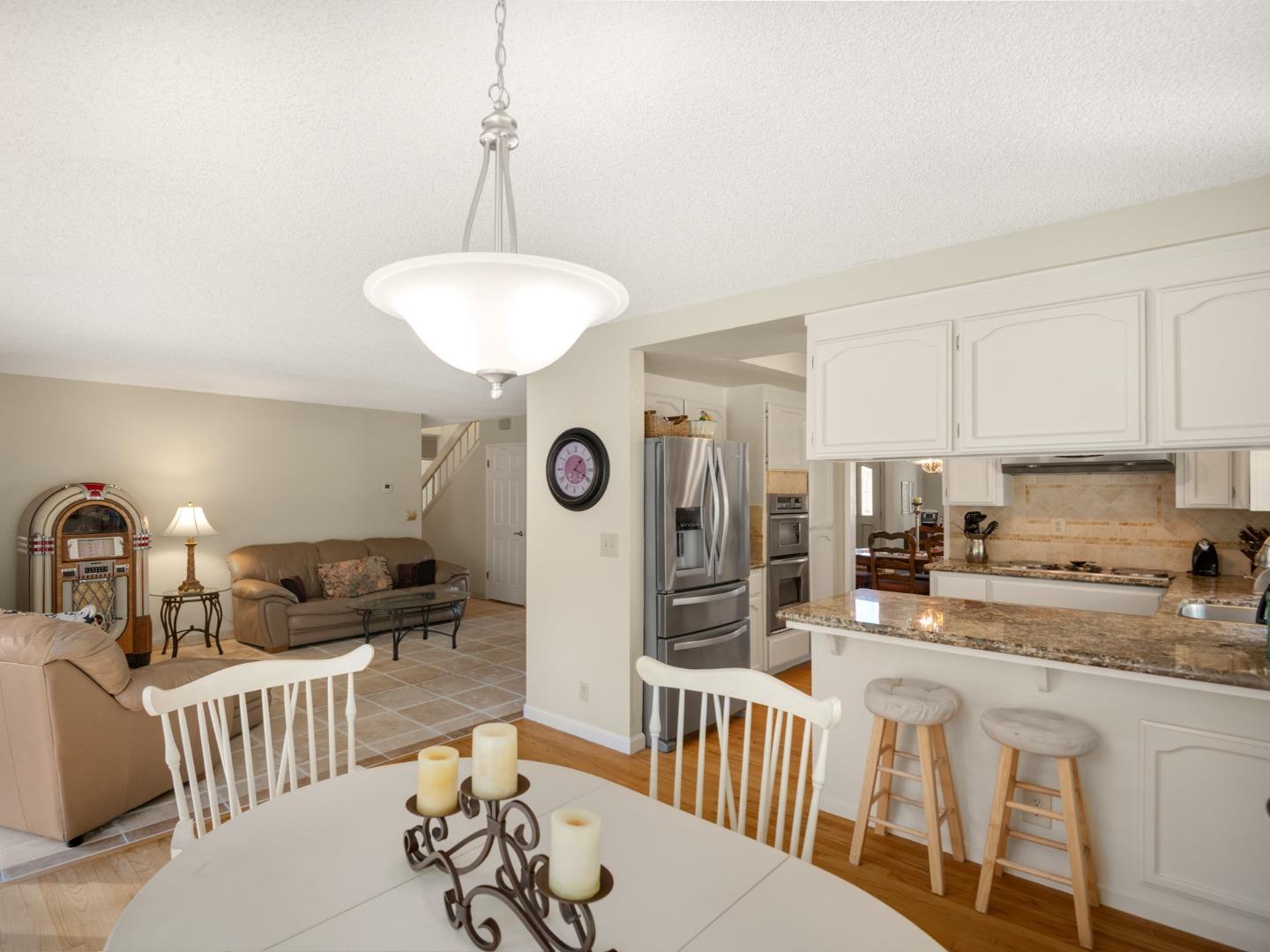 7026 Burnside Drive San Jose, CA 95120 - Photo 16 of 60 a kitchen with stainless steel appliances kitchen island granite countertop a sink and cabinets