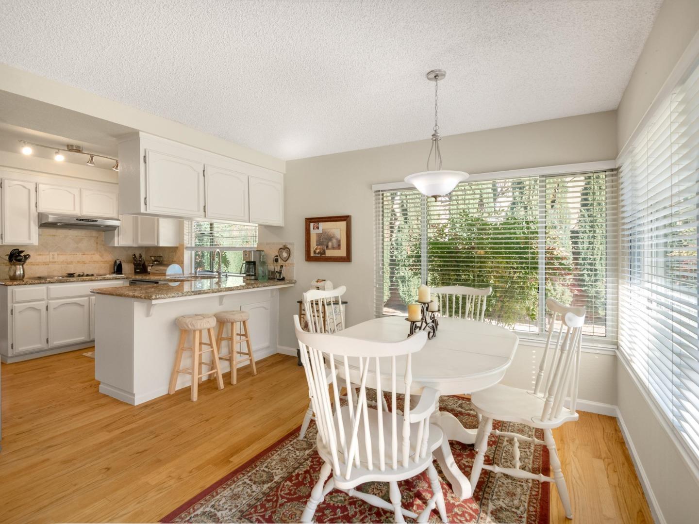 7026 Burnside Drive San Jose, CA 95120 - Photo 17 of 60 a dining room with furniture a chandelier and wooden floor