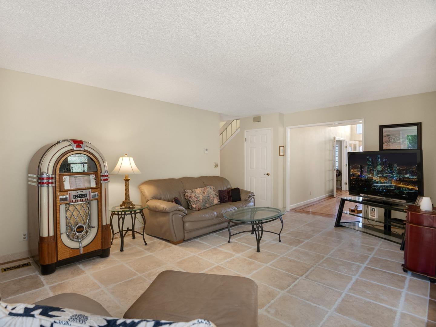 7026 Burnside Drive San Jose, CA 95120 - Photo 18 of 60 a living room with furniture a flat screen tv and kitchen view