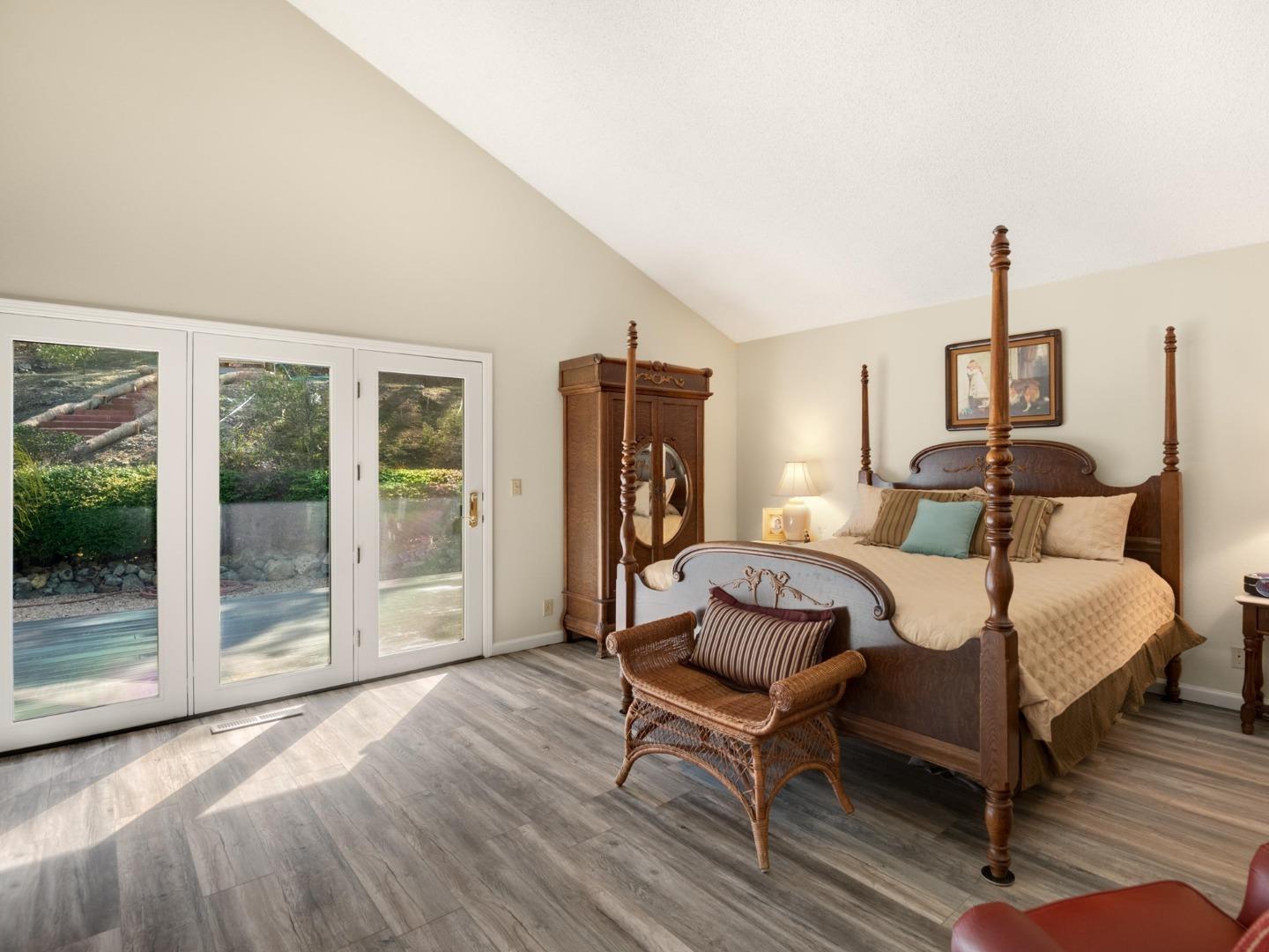 7026 Burnside Drive San Jose, CA 95120 - Photo 21 of 60 a bedroom with a bed and wooden floor