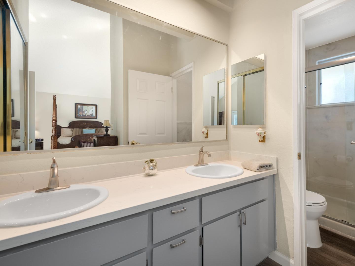 7026 Burnside Drive San Jose, CA 95120 - Photo 23 of 60 a bathroom with double sink and a mirror