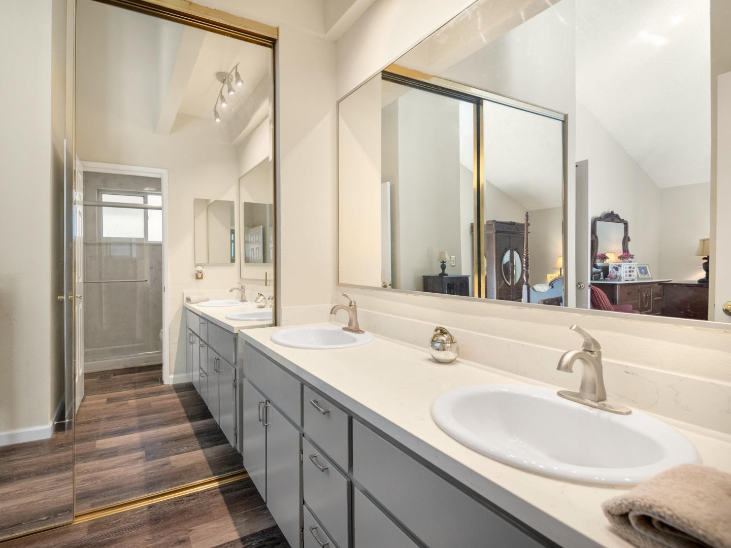 7026 Burnside Drive San Jose, CA 95120 - Photo 24 of 60 a bathroom with double vanity sinks and a large mirror