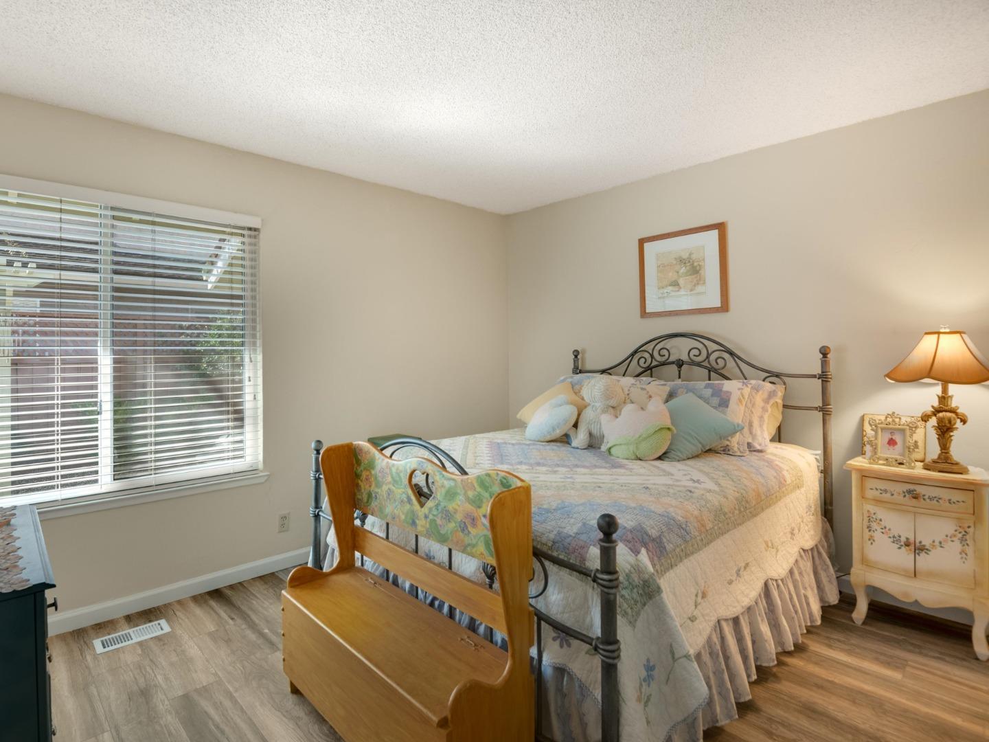 7026 Burnside Drive San Jose, CA 95120 - Photo 27 of 60 a bedroom with a bed and wooden floor