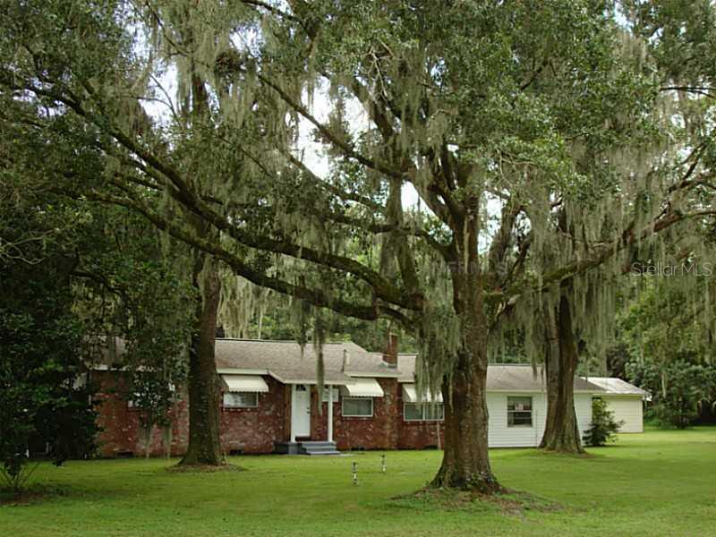 8720 Carey Road Lithia, FL 33547 - Photo 1 of 1 a front view of a house with a garden