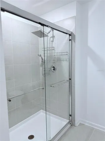 a bathroom with a glass shower door