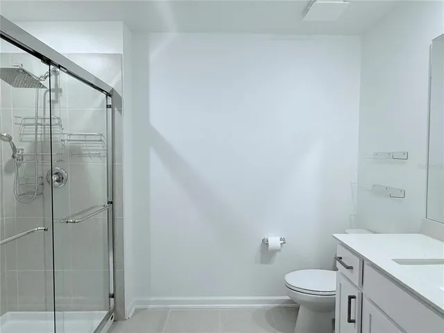 a bathroom with a shower a toilet and sink