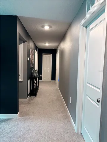 a view of a hallway with living room