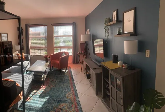 a reading room with furniture window and flat screen tv