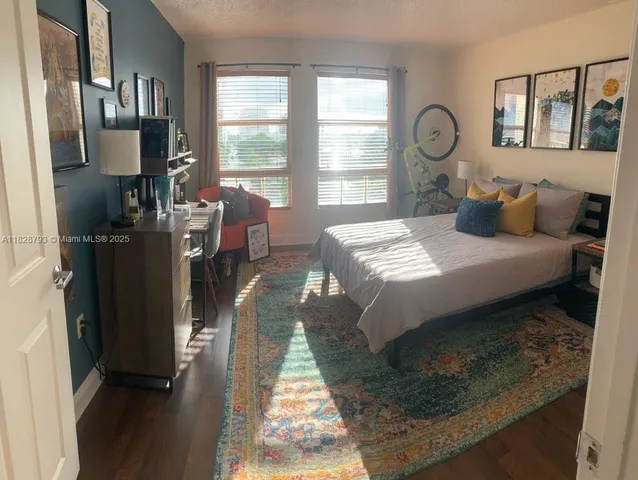 a bedroom with a bed window and a mirror