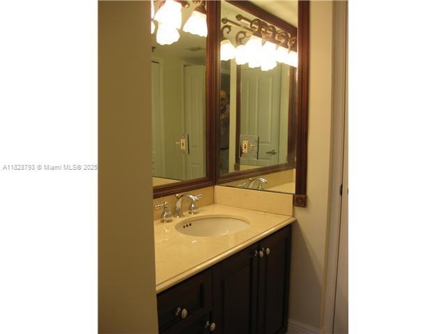 2351 Douglas Road, Unit 505 Miami, FL 33145 - Photo 7 of 13 a bathroom with a sink and a mirror