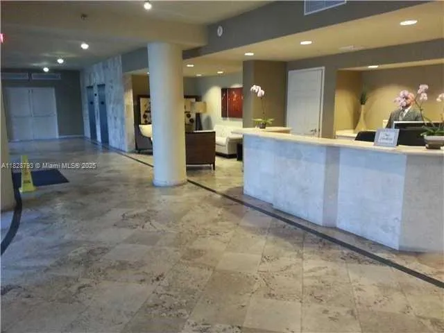 a view of kitchen with refrigerator and dining table