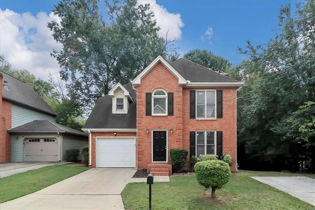 1401 Camden Walk Decatur, GA 30033 - Photo 1 of 1 a front view of a house with a yard and garage