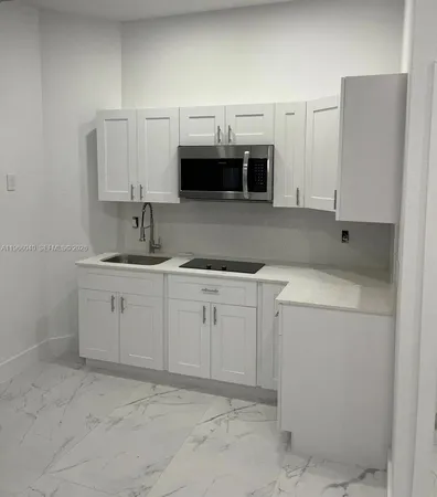 a utility room with cabinets washer and dryer