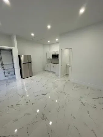 a view of a refrigerator and window in a room