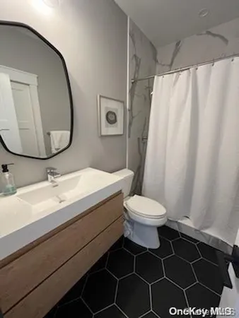 a bathroom with a sink a toilet and a mirror