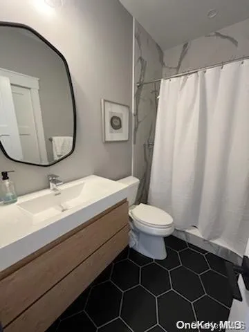 a bathroom with a sink a toilet and a mirror