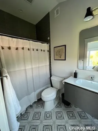 a bathroom with a toilet a sink and bathtub