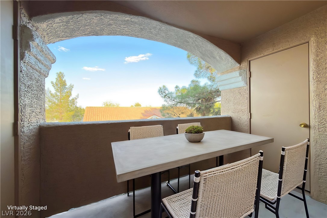 8101 West Flamingo Road, Unit 2131 Las Vegas, NV 89147 - Photo 8 of 13 An inviting private patio awaits, offering a comfortable outdoor dining area with expansive views.