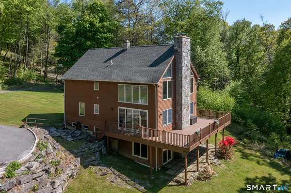 an aerial view of a house with a yard table and chairs