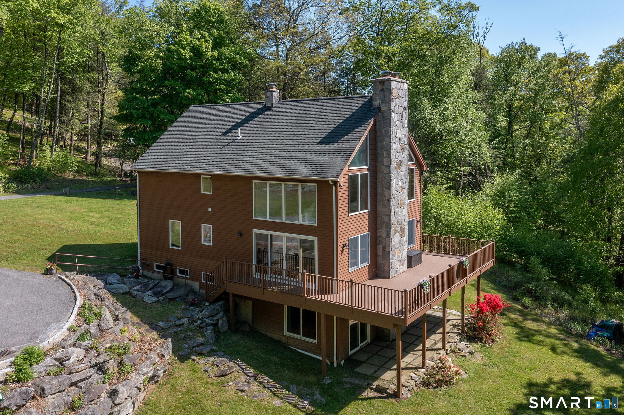 an aerial view of a house with a yard table and chairs