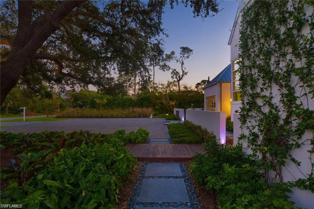581 Myrtle Road Naples, FL 34108 - Photo 36 of 39 a view of a yard with flower plants and large trees