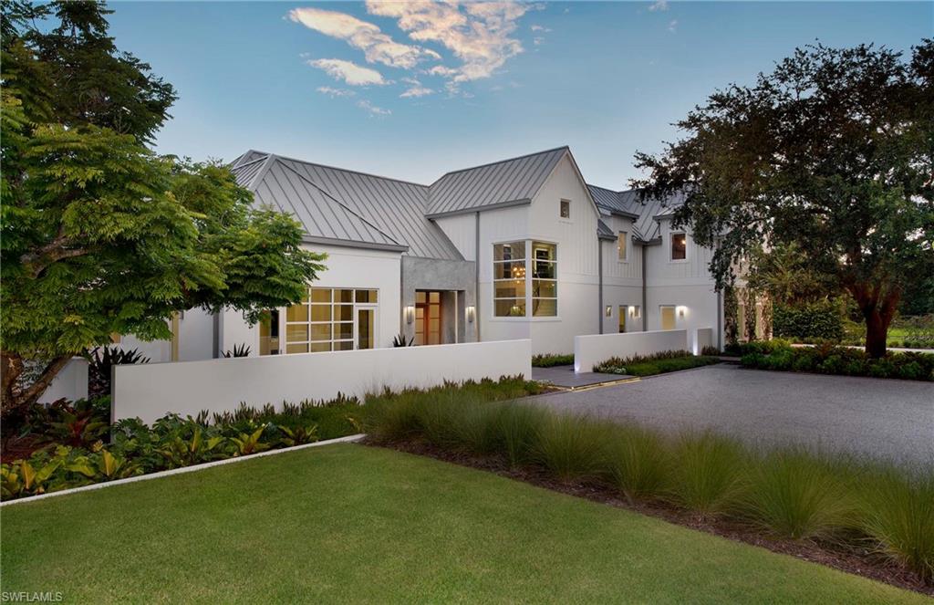 581 Myrtle Road Naples, FL 34108 - Photo 37 of 39 a front view of a house with a garden and yard