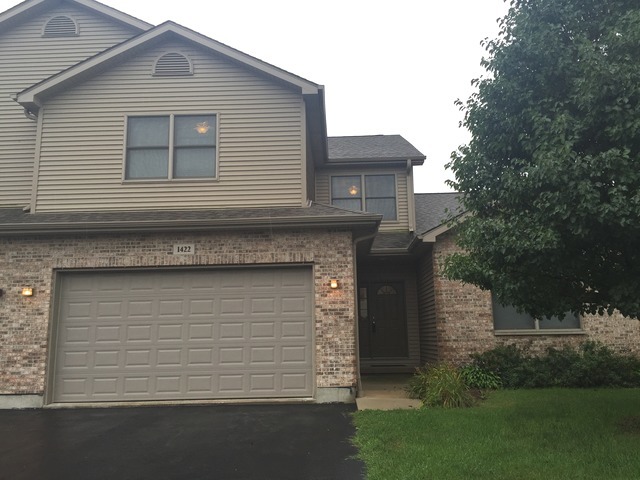 1422 Ridge Drive Sycamore, IL 60178 - Photo 1 of 21 a front view of a house with a garden