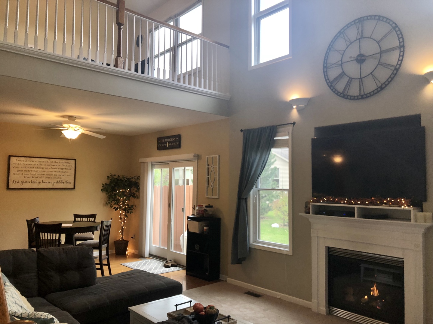1422 Ridge Drive Sycamore, IL 60178 - Photo 4 of 21 a living room with furniture a flat screen tv and a fireplace