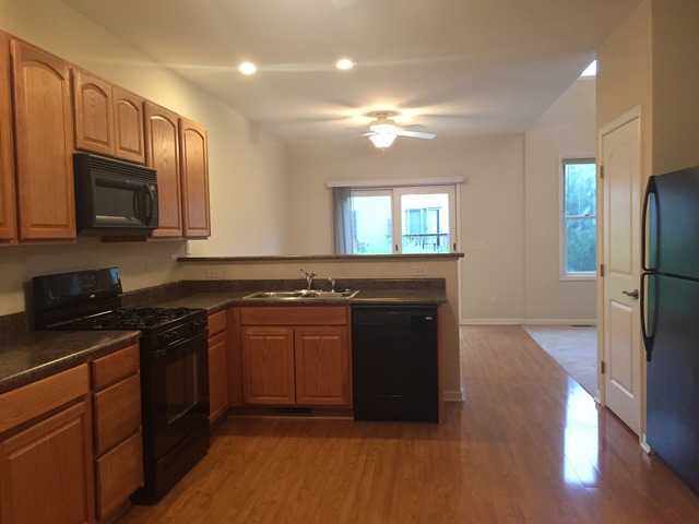 1422 Ridge Drive Sycamore, IL 60178 - Photo 7 of 21 a kitchen with stainless steel appliances granite countertop a stove a refrigerator and a microwave
