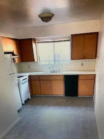 a kitchen with a sink and a stove top oven