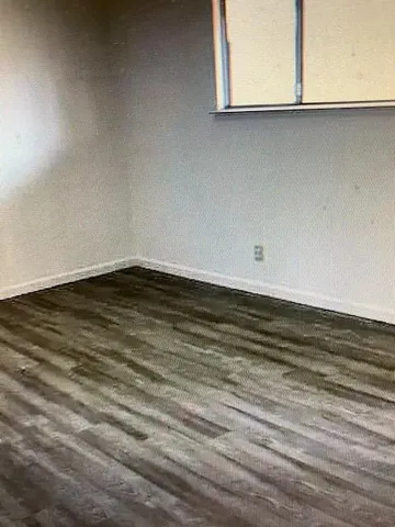 a view of wooden floor and a window