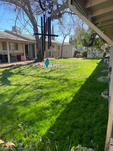 a view of a house with a backyard porch and sitting area