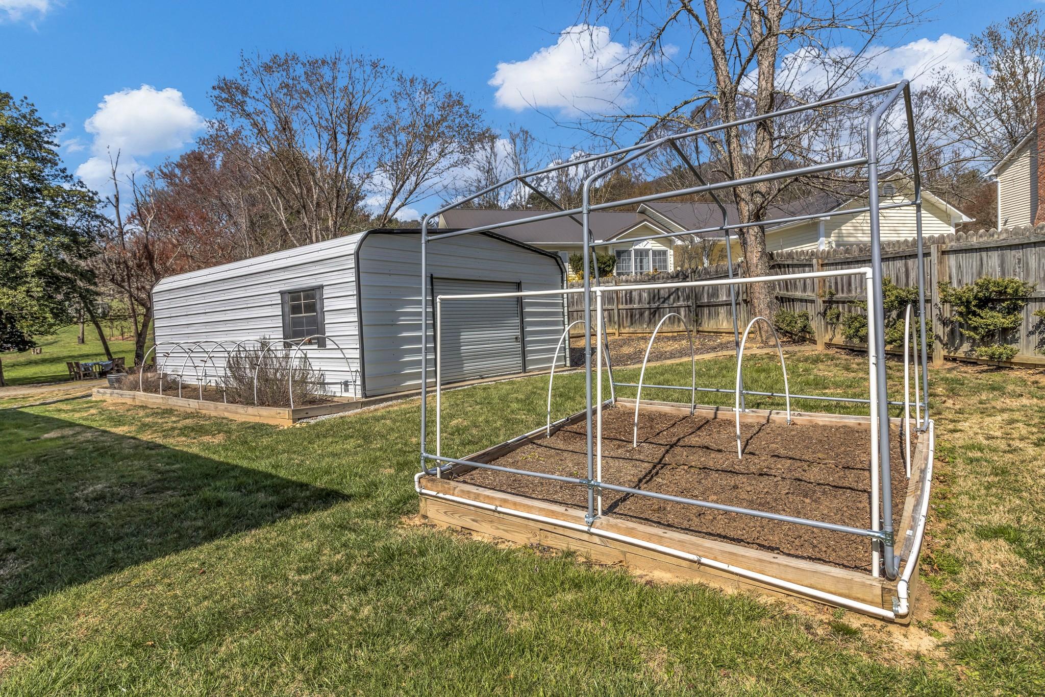 994 Riceville Road Asheville, NC 28805 - Photo 18 of 45 a view of a backyard with a garden and plants